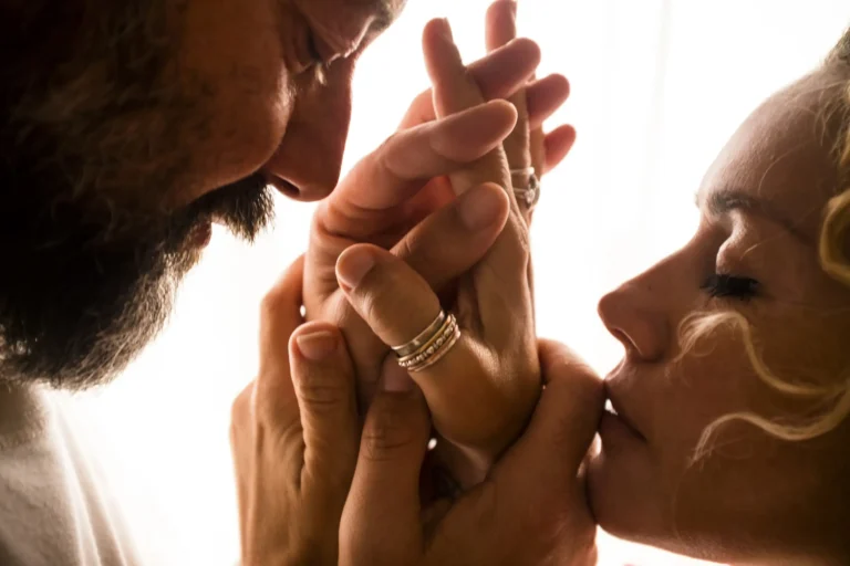 Two lovers holding their hands and closing their eyes.