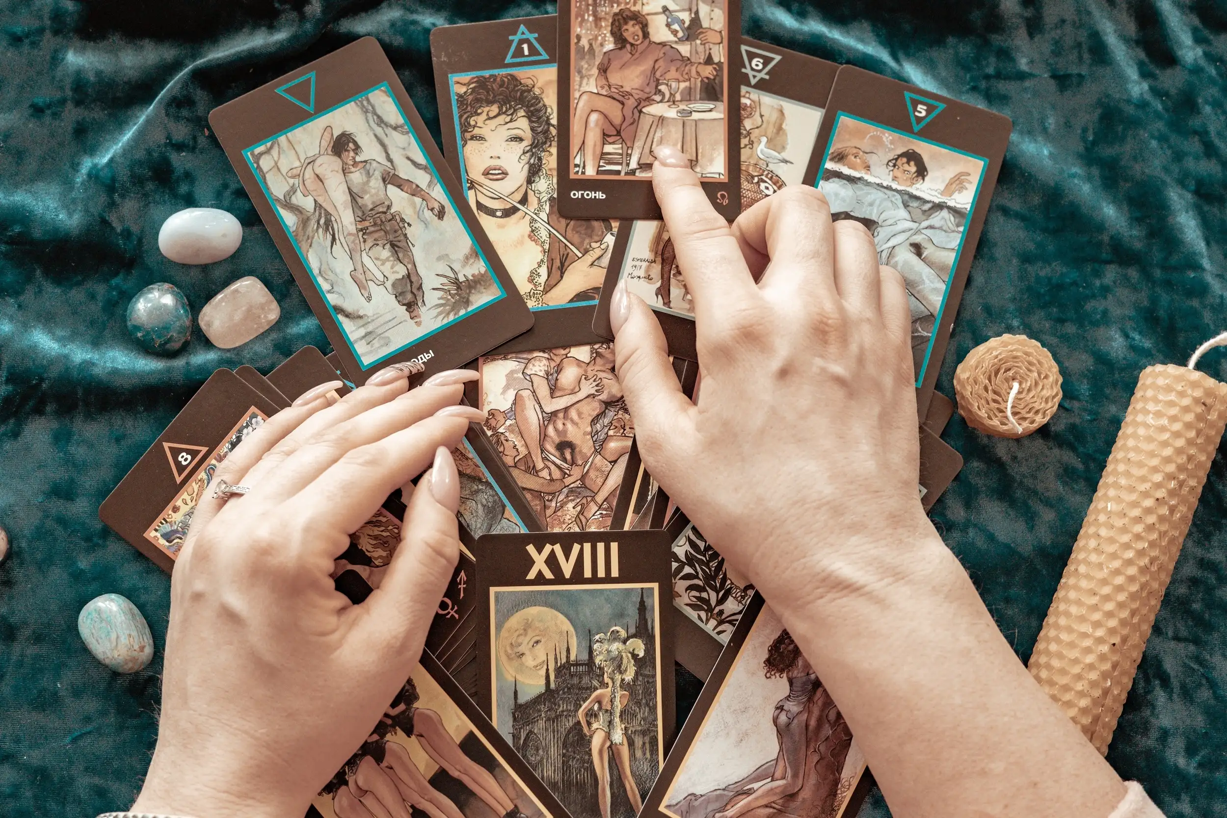 A table with tarot cards read by the fortune teller's hands.