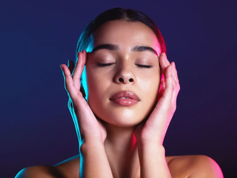 A beautiful woman closing her eyes and touching her head.