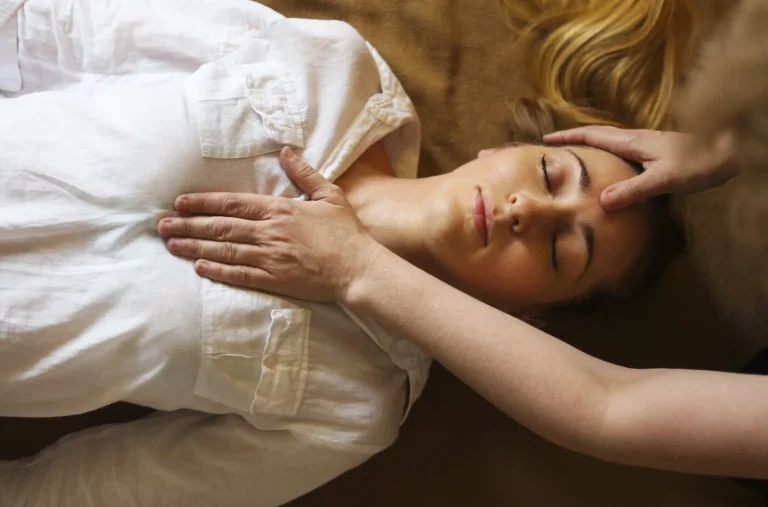 A woman getting her chakra healing session.